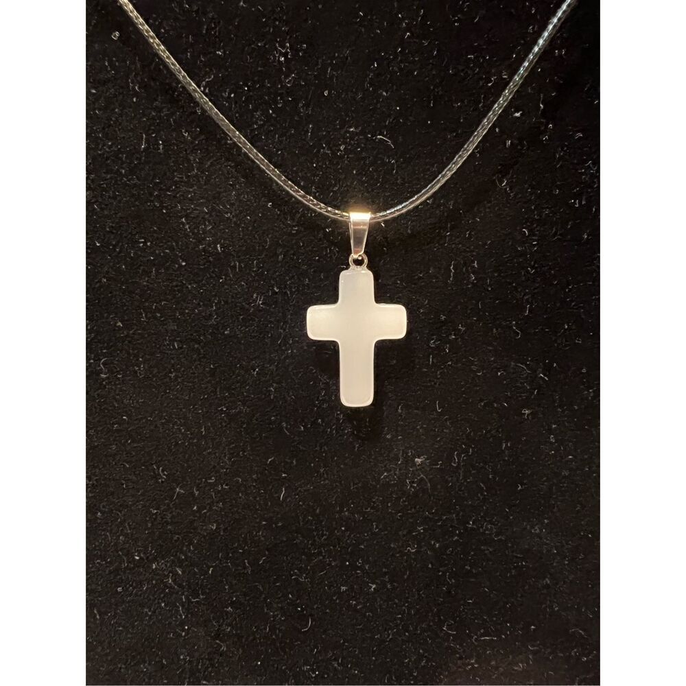 White Stone Cross on a Black Necklace Cord